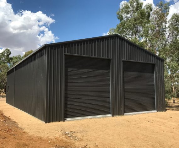 An enclosed garage shed with two sliding doors
